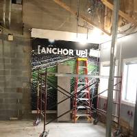 Sign in the photo says, Anchor Up! It's in a room under construction.